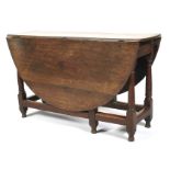 An 18th century oak oval topped gate leg table.