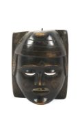 A 20th century large carved wooden tribal wall mask.