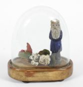 A Victorian table top Christmas decoration under glass dome.