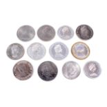 Twelve crown-size world coins, some silver.
