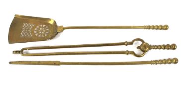 A set of 19th century brass fire tools.