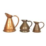 Three late 19th century copper graduated jugs. One stamped Gallon, The largest 41cm high max.