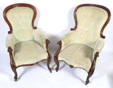 A pair of Victorian mahogany framed balloon-shaped button back armchairs.