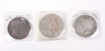 Three USA silver dollars for 1889, 1923, 1992.
