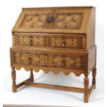 A 20th century inlaid oak fall front bureau.