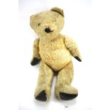 A 1950s teddy bear with articulated limbs,
