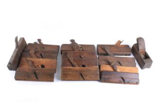 A box of assorted vintage mahogany planes.