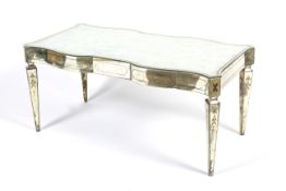 A mirrored glass coffee table of unusual design.