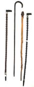 An assortment of four walking canes.