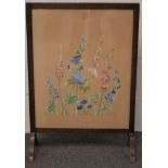 A 20th century stained wooden fire screen.