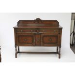 An oak sideboard with beaded decoration.