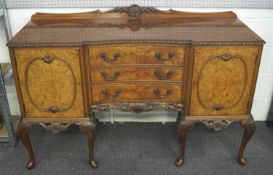 A walnut sideboard with carved gallery back and frieze.