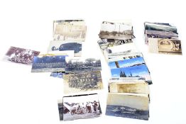An assortment of postcards including early 20th century military examples.