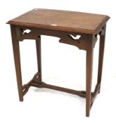 An oak Arts & Crafts side table with pierced decoration.