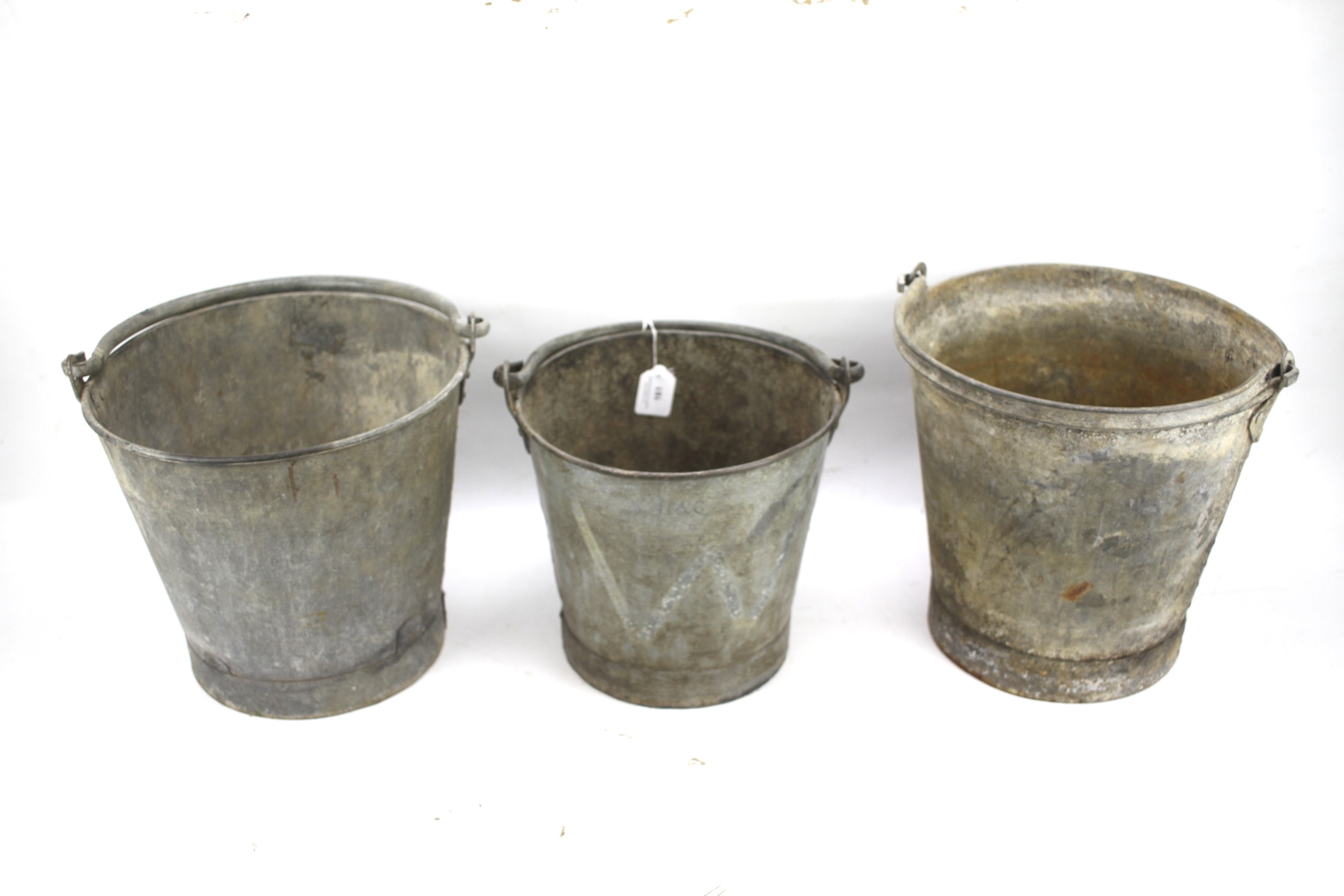 Three galvanized pales with swing handles.