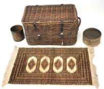 A vintage wicker two handled laundry hamper and other items.