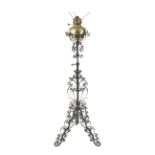 A wrought iron work tripod oil standard lamp with reservoir.
