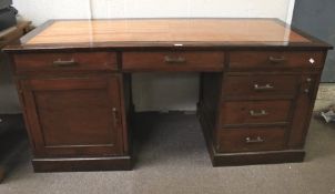 A 20th century stained pine twin pedestal desk.