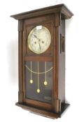 A 1930s oak cased eight day wall clock.