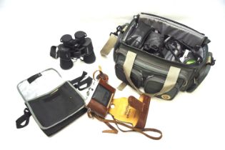 An assortment of cameras and accessories. Including an Olympus OM10 35mm SLR camera with 50mm 1:1.