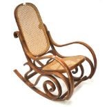 A 20th century Thonet style bentwood rocking chair with cane rattan back and seat.