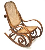 A 20th century Thonet style bentwood rocking chair with cane rattan back and seat.