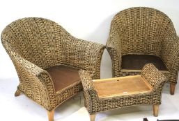 A pair of wicker conservatory/garden elbow chairs and a lidded foot stool.