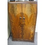 A 1930s mahogany child's wardrobe.