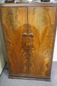 A 1930s mahogany child's wardrobe.