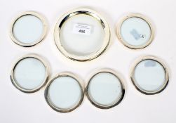 A set of six contemporary silver mounted glass coasters.