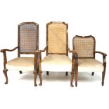 A pair of 20th century elbow chairs and a single elbow chair.