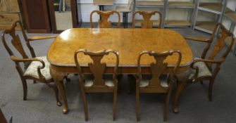 A fine burr walnut dining table and a set of six 2+4 Queen Anne style chairs.