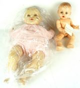 A 1950s Rosebud doll and a 1980s baby with dummy