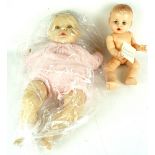 A 1950s Rosebud doll and a 1980s baby with dummy