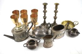An assortment of metalware and silver plate. Including teapots, goblets, candlesticks, etc.