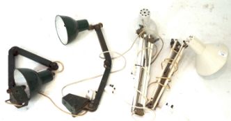 An assortment of four anglepoise work bench lamps.