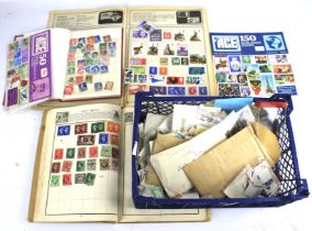 A basket of assorted stamp albums with an assortment of world stamps.