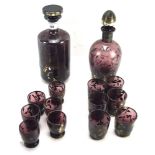 Two early 20th century glass decanters with matching glasses.