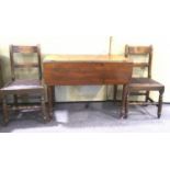 A Victorian mahogany drop leaf table and two dining chairs.