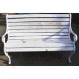 A white painted metal garden bench.