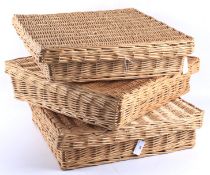 Three contemporary lidded wicker baskets.