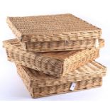 Three contemporary lidded wicker baskets.