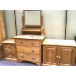 A pine dressing table, bedside cabinet and a TV cabinet.