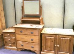 A pine dressing table, bedside cabinet and a TV cabinet.