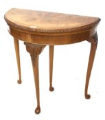 A burr walnut demi-lune foldover card table.