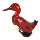 A Royal Doulton flambe figure in the form of a duck.