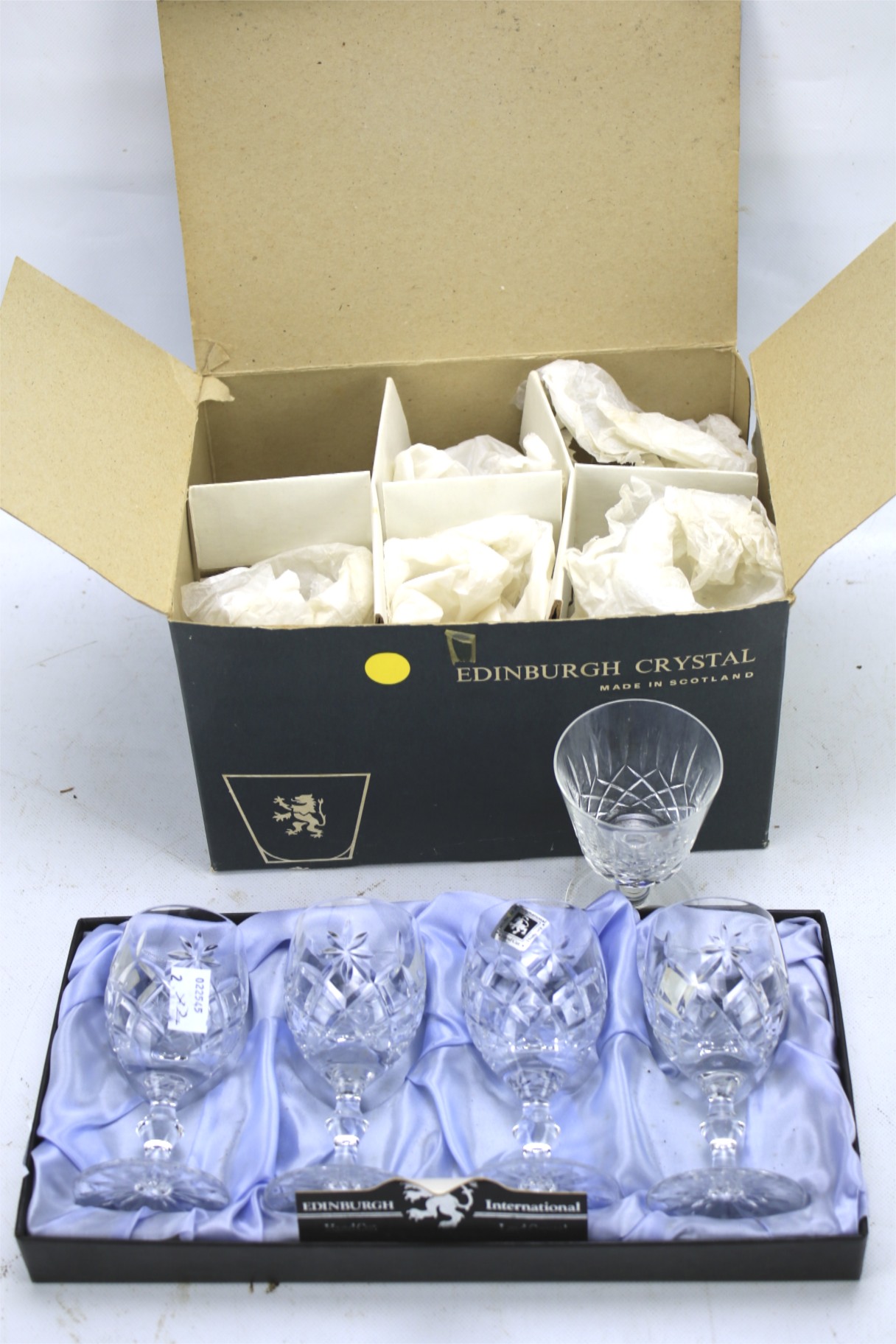 Two sets of Edinburgh Crystal drinking glasses.