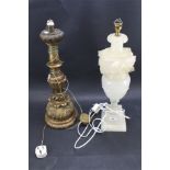 A cream alabaster table lamp and a gilt wood example. Both carved with leaves.