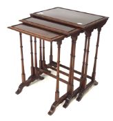 A nest of three mahogany occasional tables.