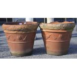 A pair of large terracotta pots. Of tapering cylindrical form, moulded with garlands, 45.